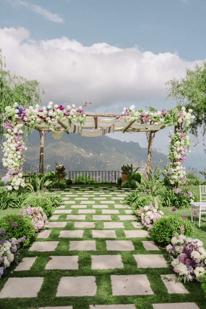 Wedding ceremony arch with flowers overlooking a lake